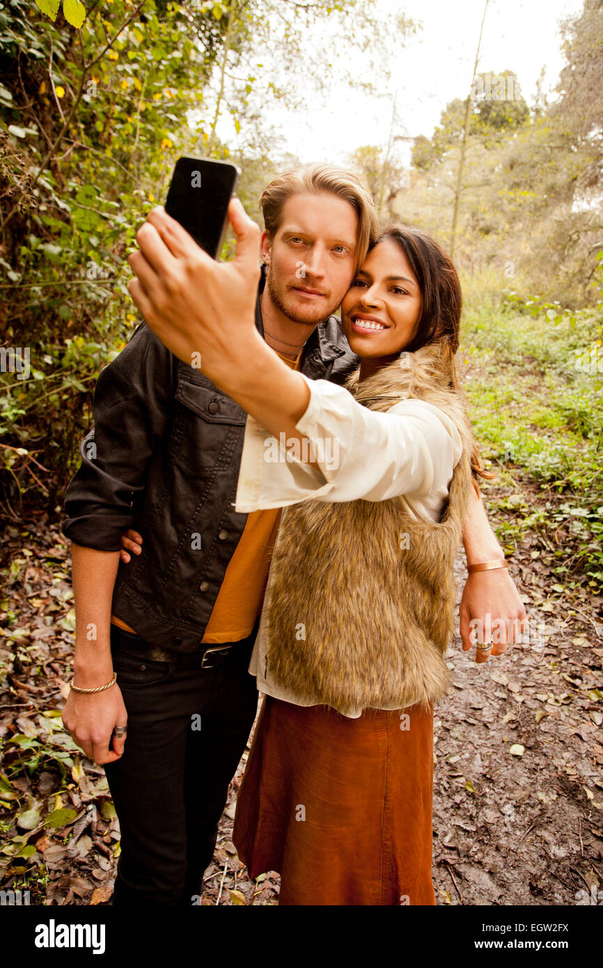 Woman and man taking a selfie in the woods. Stock Photo