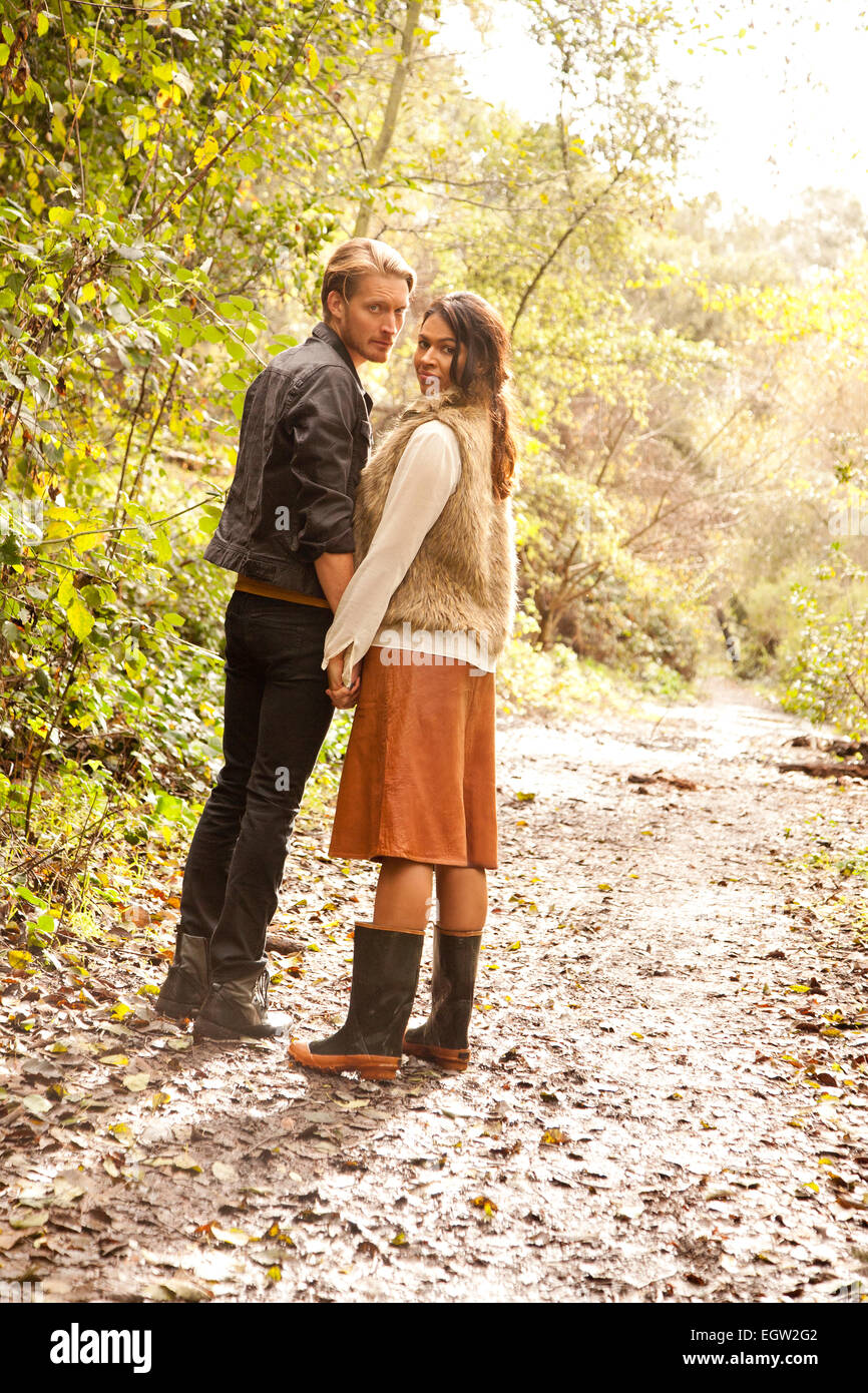 Woman and man on path in woods. Stock Photo
