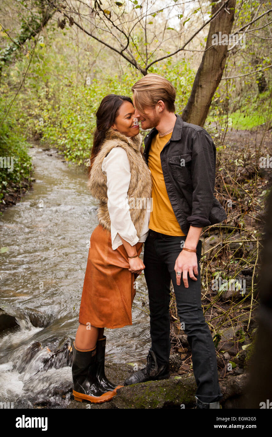 Woman and man about to kiss near creek. Stock Photo