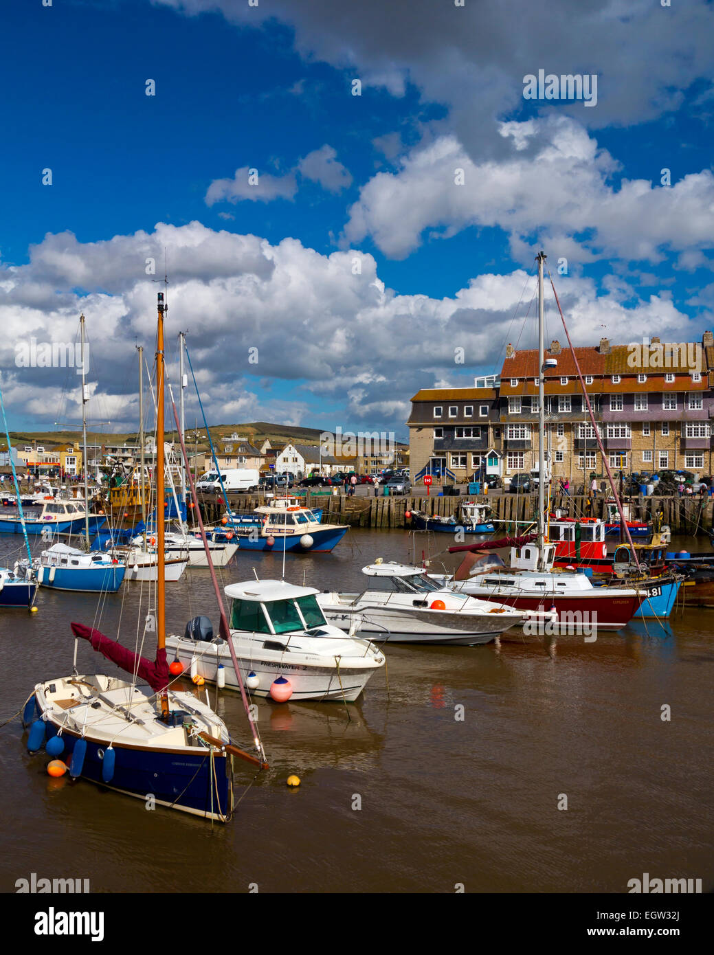 Boats moored in the harbour at West Bay a small fishing port near Bridport on the Jurassic Coast in Dorset south west England UK Stock Photo