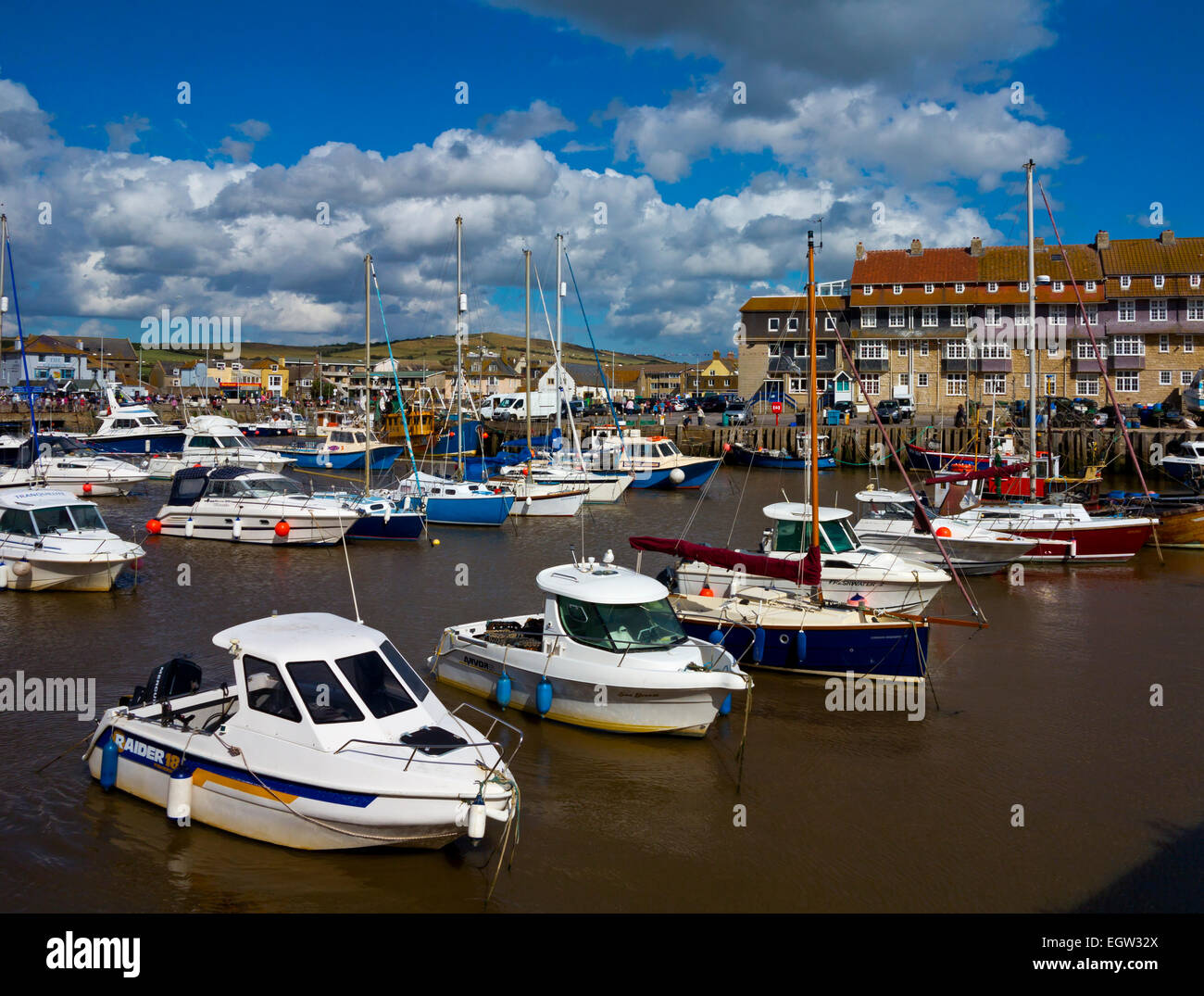 Boats moored in the harbour at West Bay a small fishing port near Bridport on the Jurassic Coast in Dorset south west England UK Stock Photo