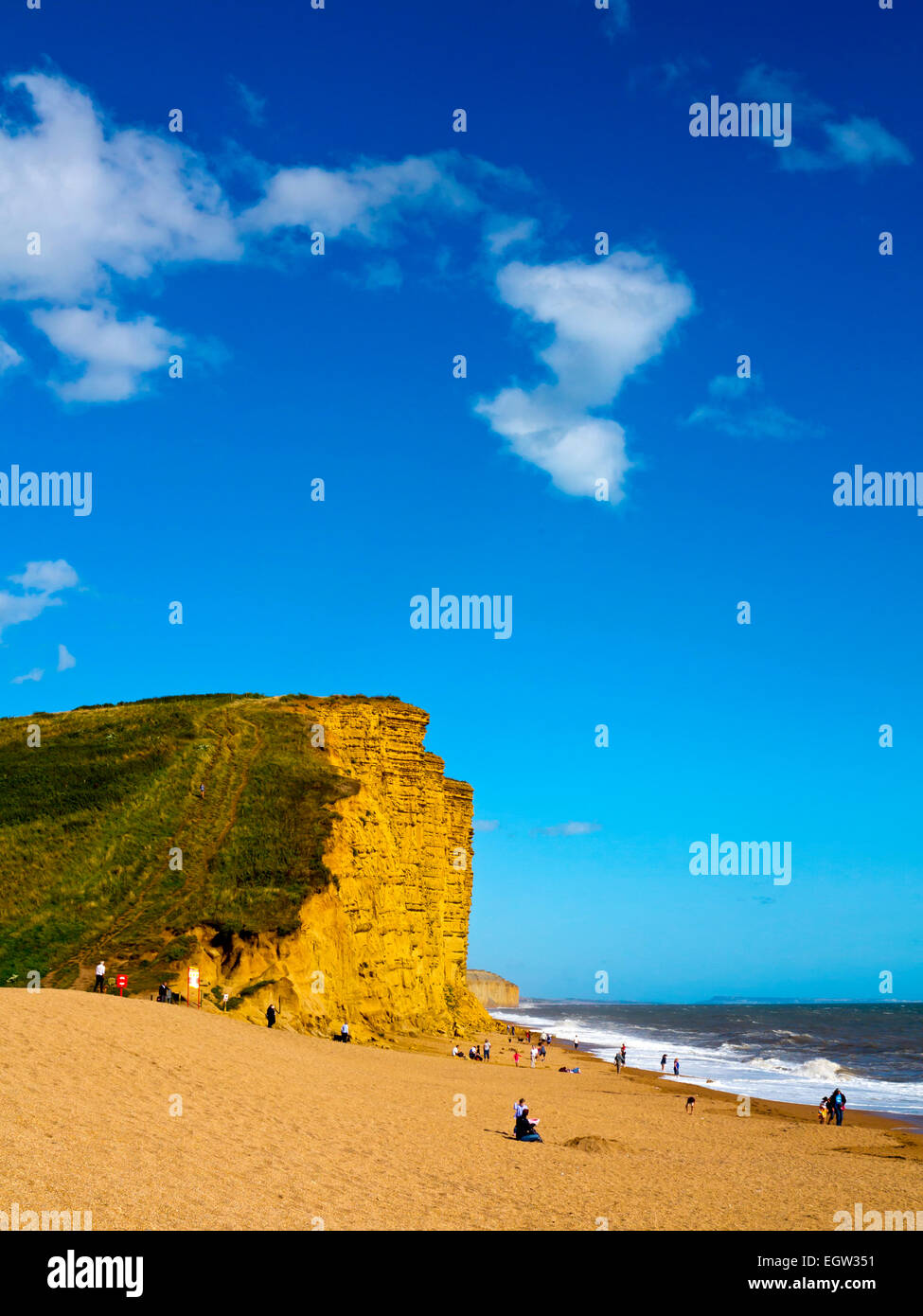 Sandstone cliffs and beach in summer on the Jurassic Coast near West Bay in Dorset south west England UK Stock Photo