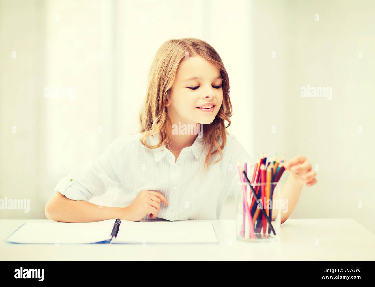 girl drawing with pencils at school Stock Photo - Alamy