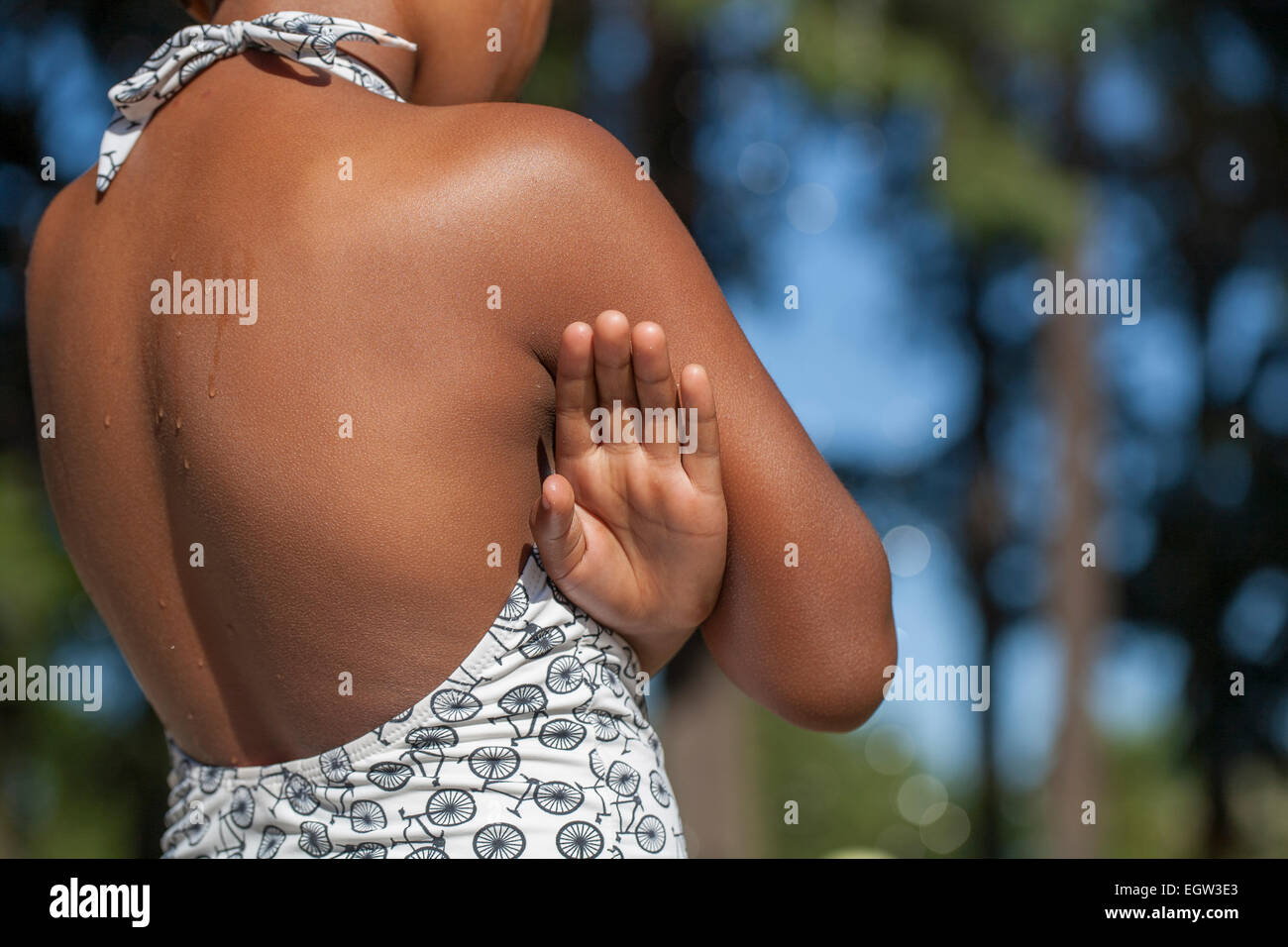 Girl crossing her arms in a bathing suit. Stock Photo