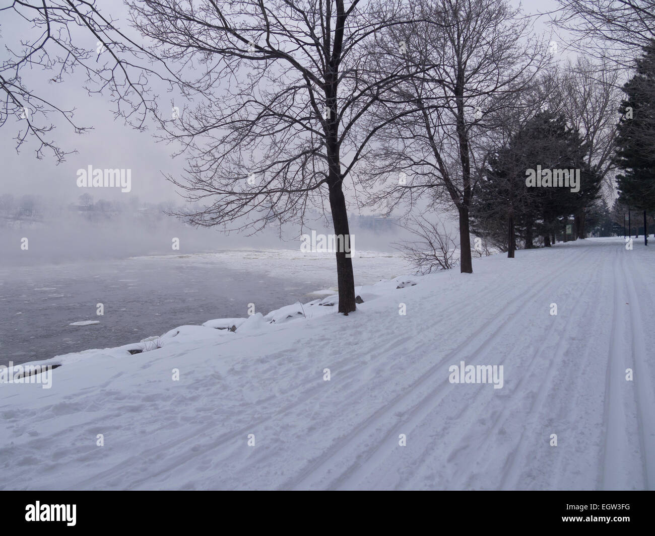 Fog on the river with ski traces on an overcast day in winter Stock Photo