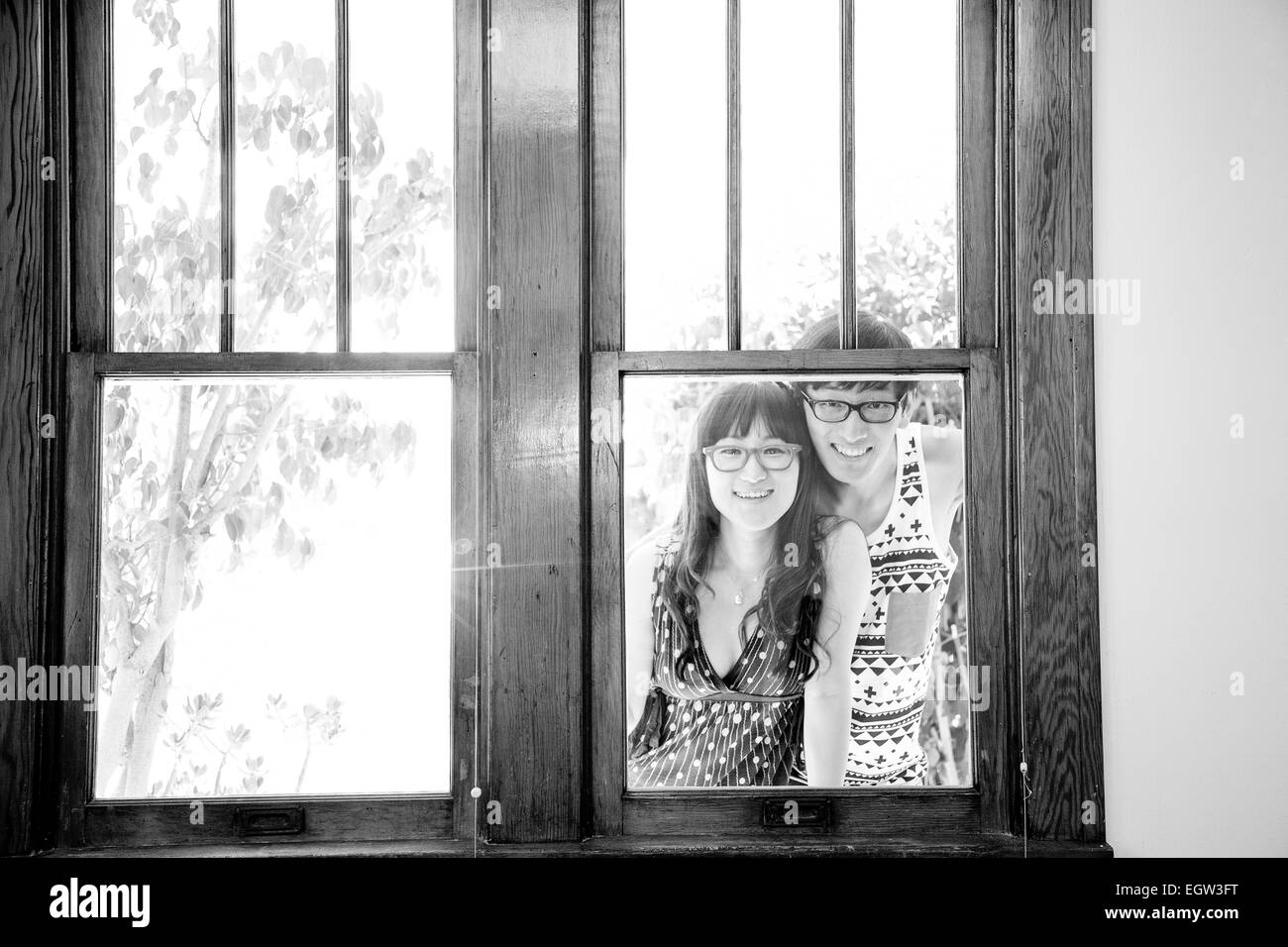 Couple looking through window. Stock Photo