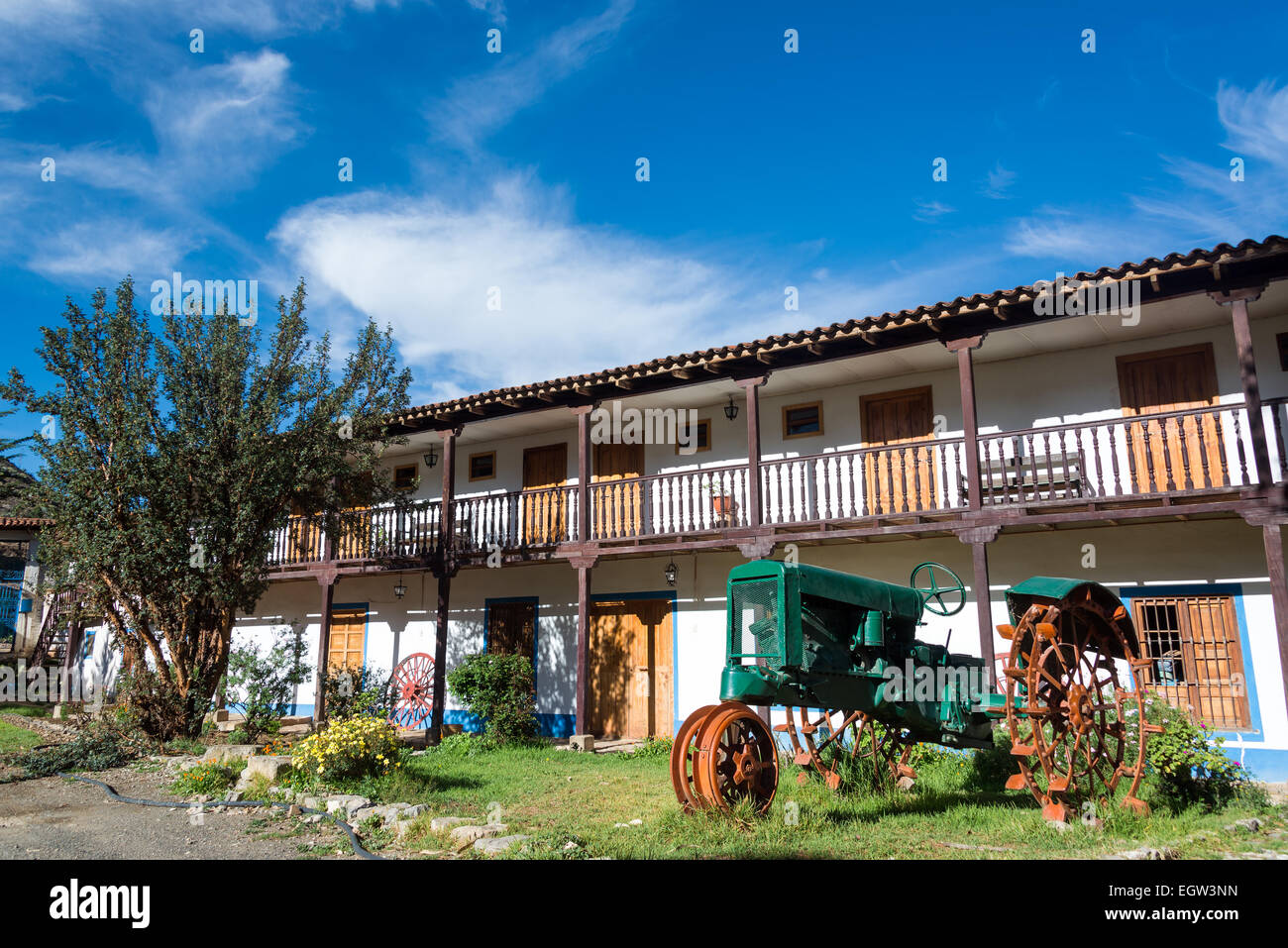 Historic colonial building and antique green tractor in Tarma, Peru Stock Photo