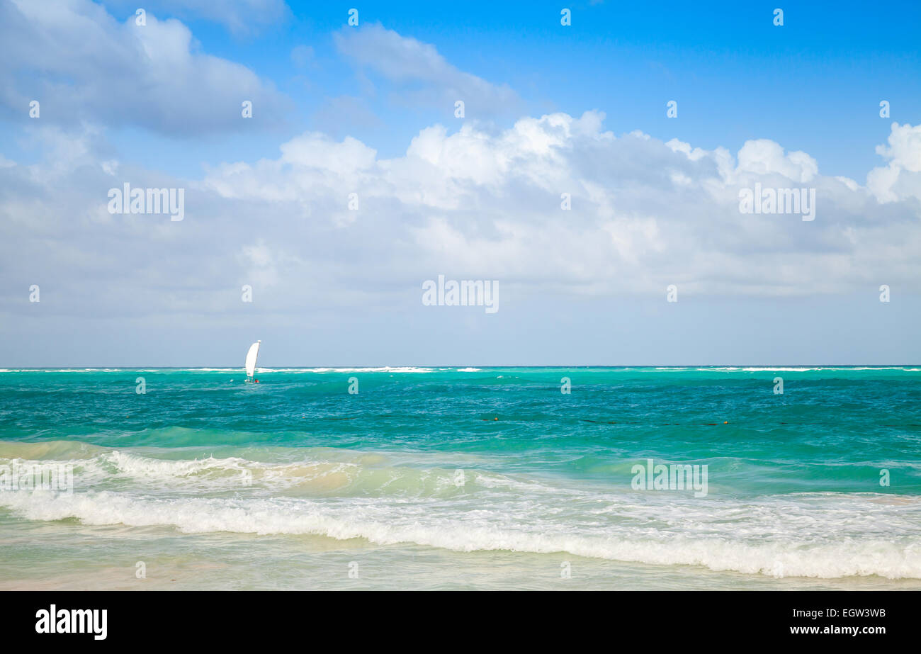 Bright sea landscape with cloudy sky and lonely sail. Atlantic ocean, Dominican republic. Punta Cana Stock Photo