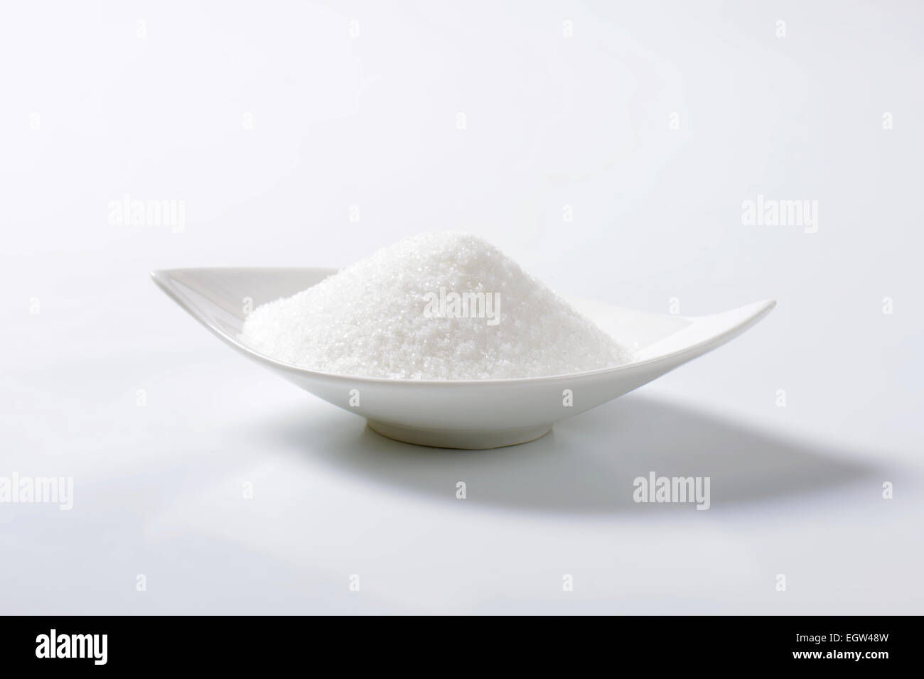 White granulated sugar in ceramic bowl Stock Photo
