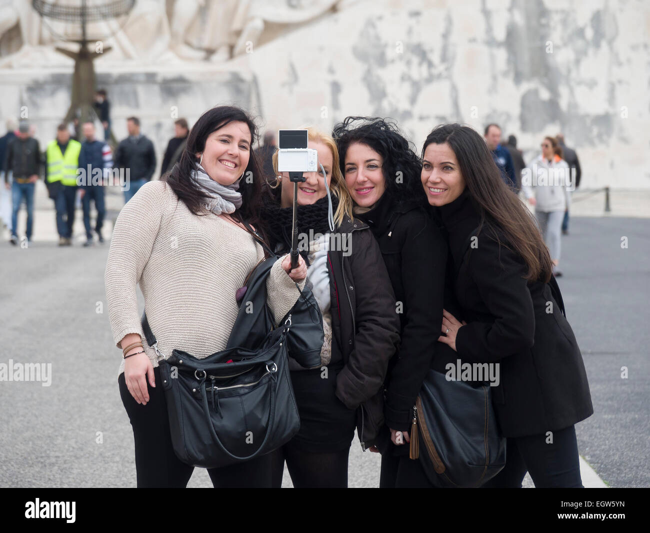 Group of teenage girls taking a selfie using a selfie stick Stock Photo