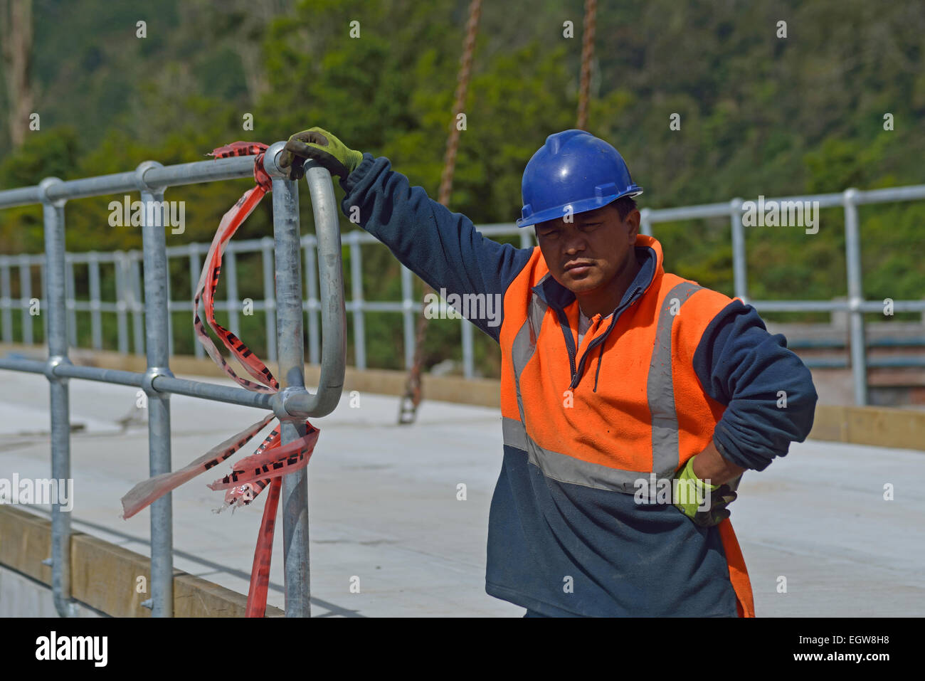 Portrait of builder on a bridge-building site at a small river in Westland, New Zealand Stock Photo