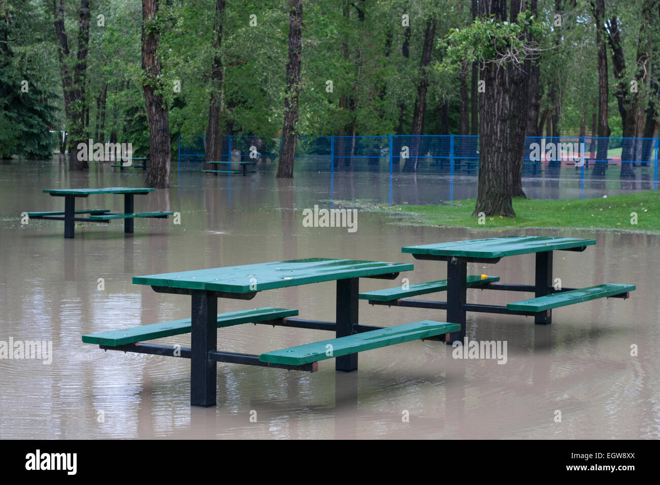 Picnic tables in water on Prince's Island Park after being flooded by