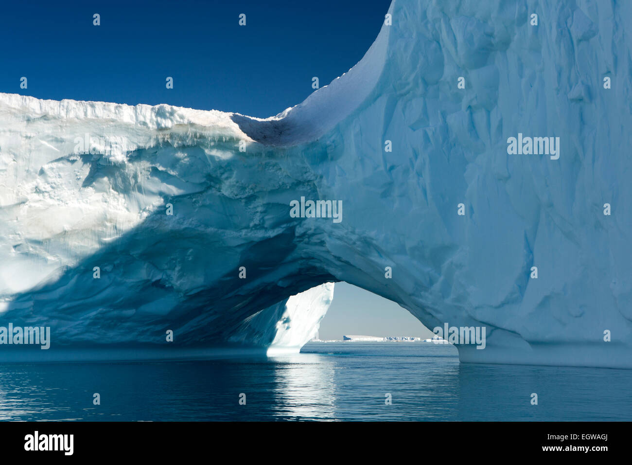Antarctica, Weddell Sea, large Antarctic iceberg with natural arch through Stock Photo