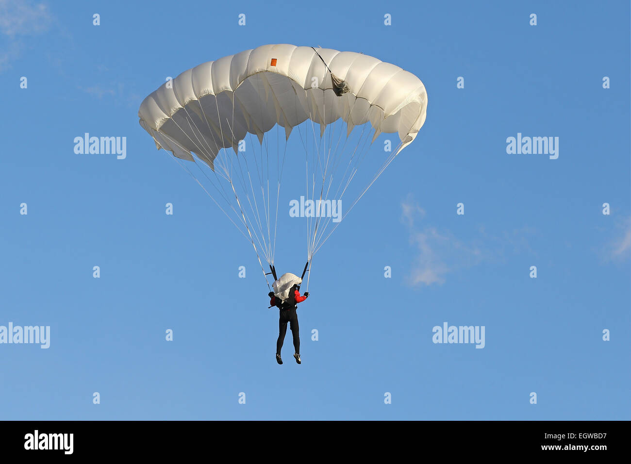 Skydiver with white parachte Stock Photo