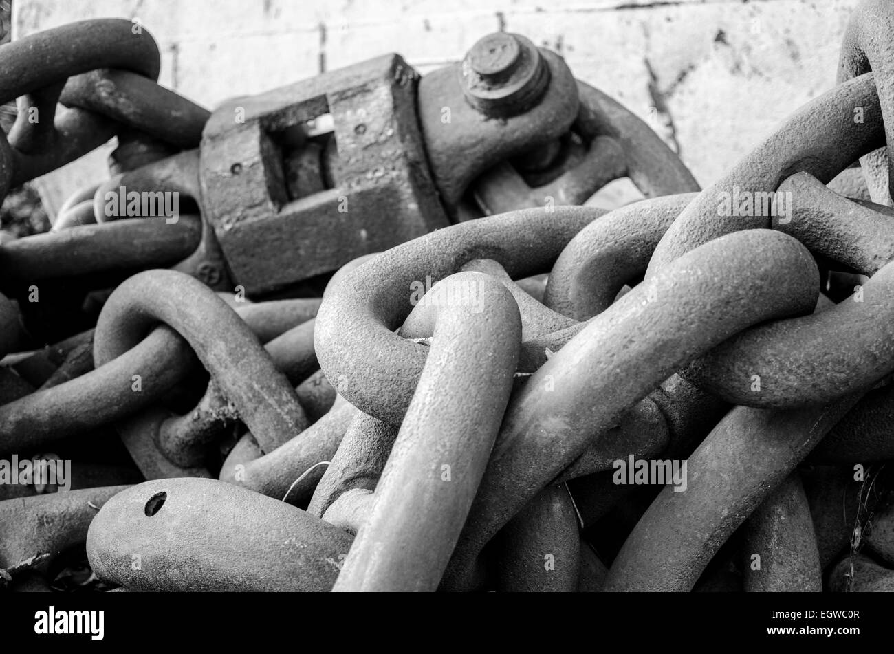 These huge chains are used to anchor mooring buoys for ships and boats. They are enormous and  perfectly weathered metal. Stock Photo