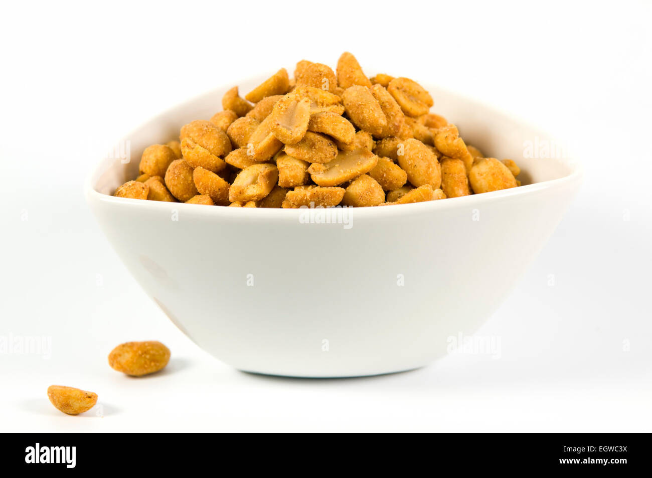 Spicy chilli coated peanuts in white bowl on white background Stock Photo