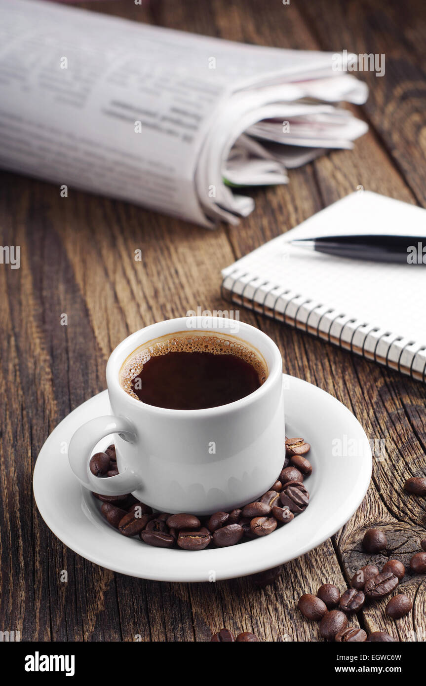 Coffee cup and newspaper on vintage wooden table Stock Photo