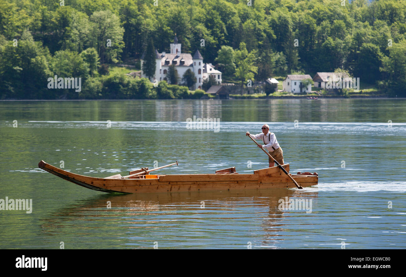 Barge with a rower on Lake Hallstatt or Hallstätter See lake, UNESCO World Heritage Site, Hallstatt-Dachstein Salzkammergut Stock Photo