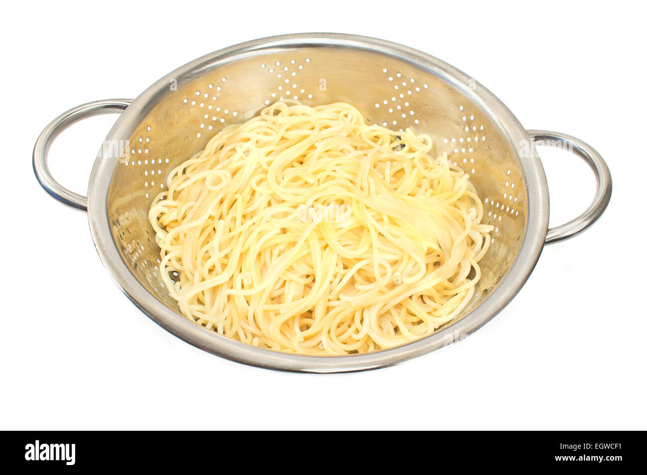 Fresh cooked spaghetti in stainless strainer isolated on white Stock Photo