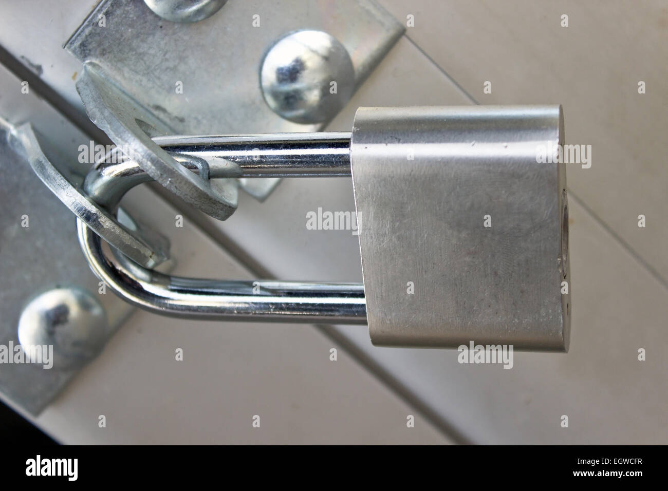 Closed padlock on a metal door Stock Photo Alamy