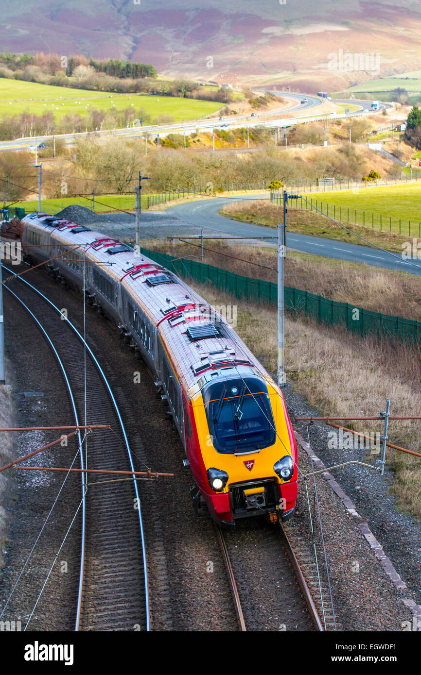 Carriage, Trains, tracks & passengers on British Railways descending Virgin Voyager Train at Shap, West Coast Main Line, Tebay, Cumbria, UK Stock Photo