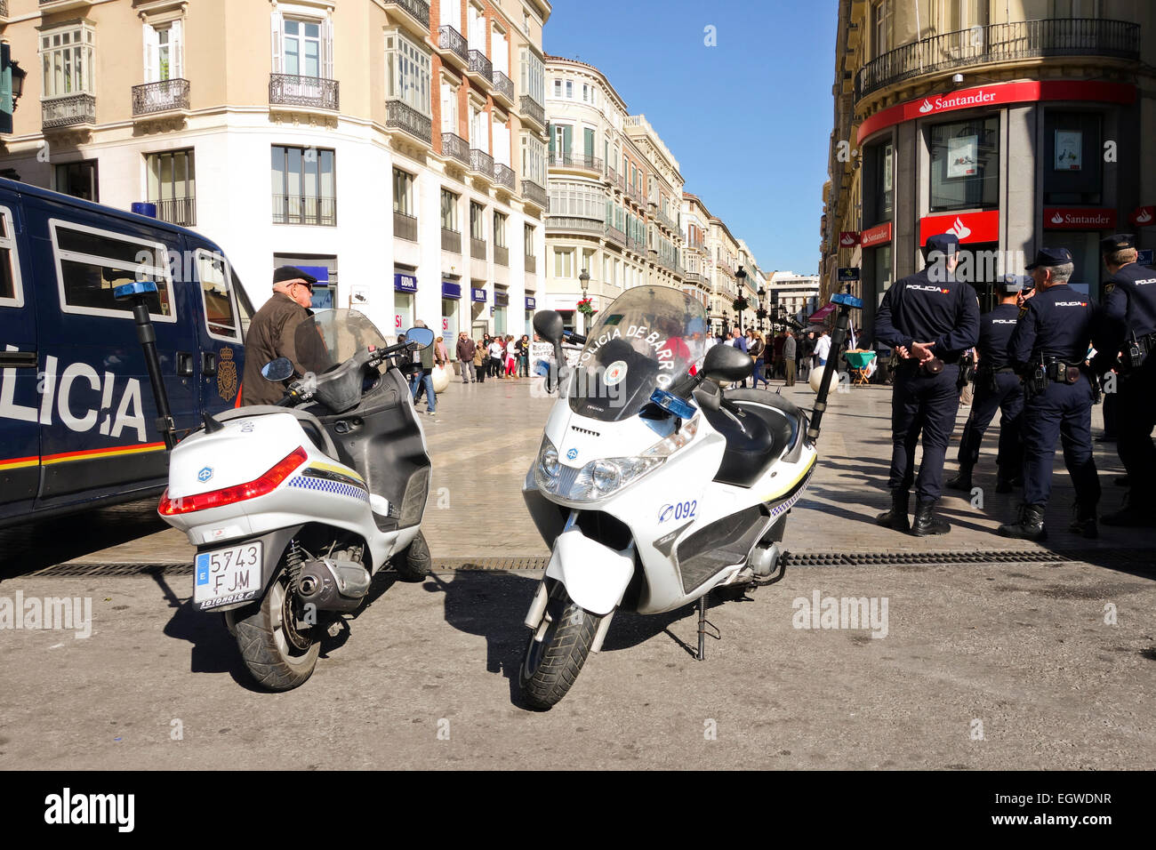 Spanish local police officers patrolling demonstration, street protest, city, Malaga, Andalusia, Spain. Stock Photo