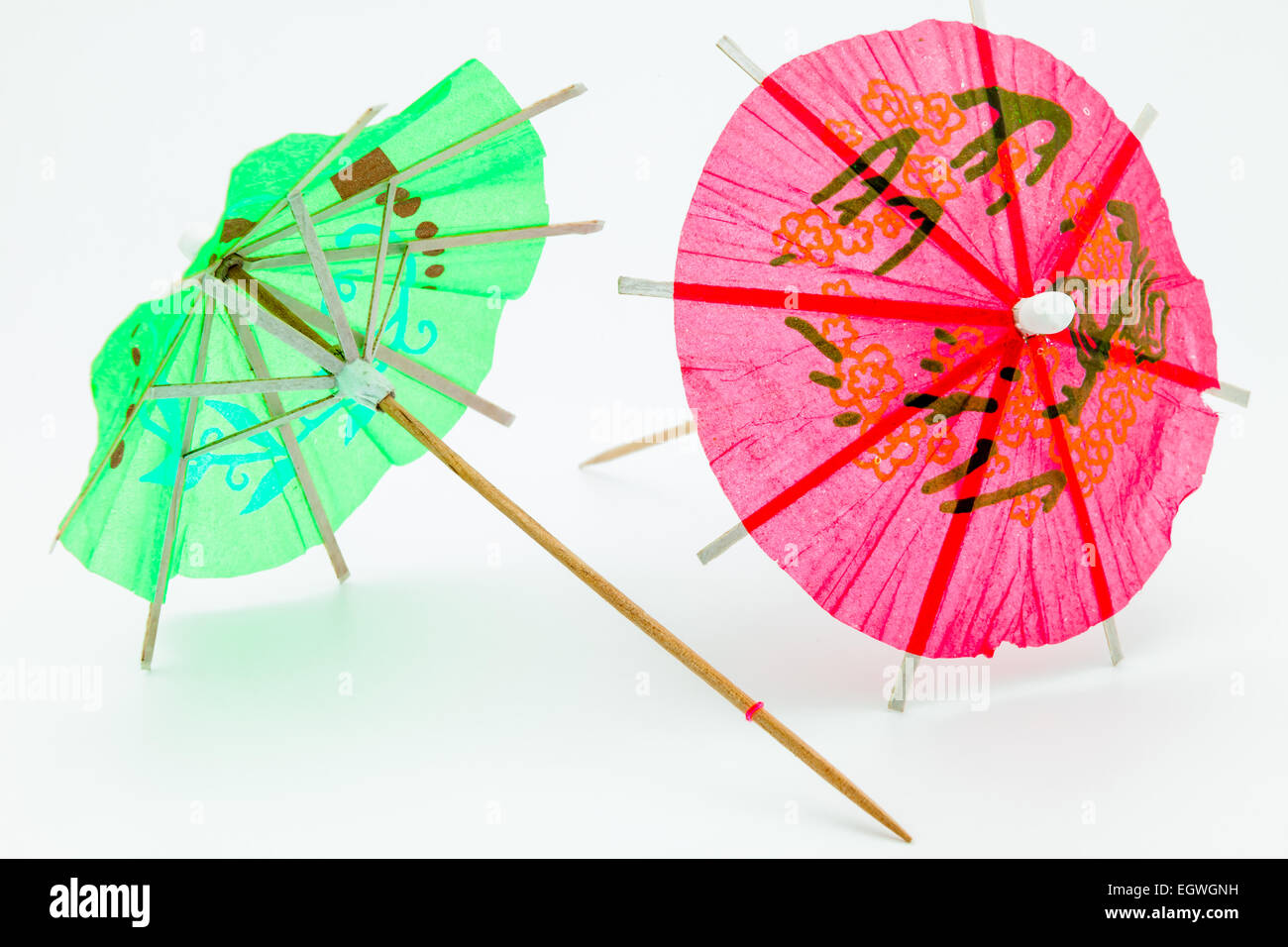 Two cocktail umbrellas on a white background Stock Photo