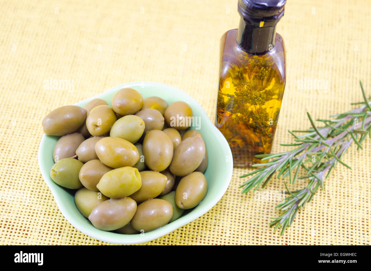 Fresh green olives and a bottle of virgin olive oil Stock Photo - Alamy