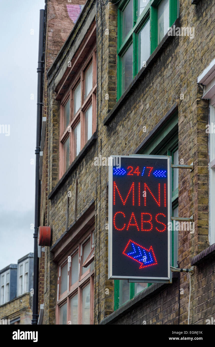 Mini Cabs sign outside a building in East London, UK Stock Photo