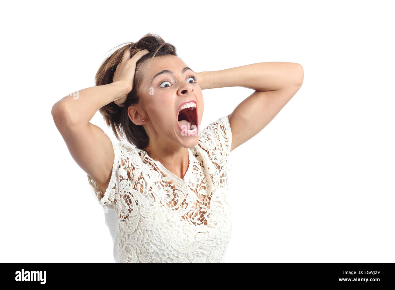 Scared crazy woman crying with hands on head isolated on a white
