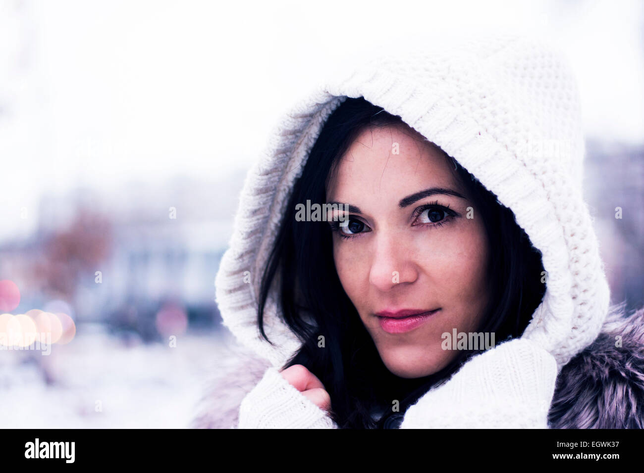Pretty woman looking wearing the knitwear hood Stock Photo