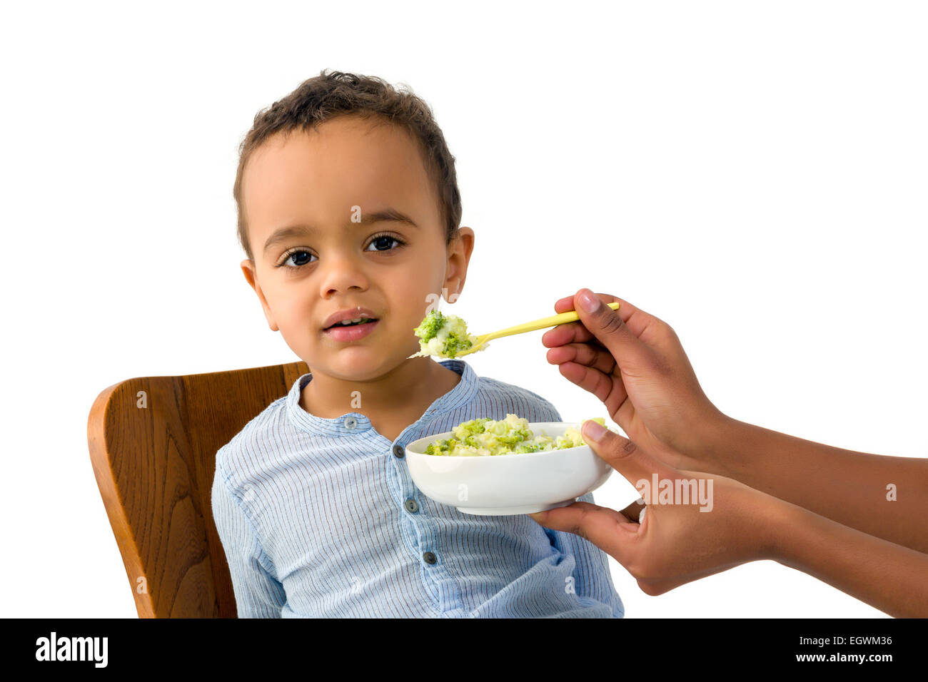 Little 18 month African toddler boy refusing to eat his vegetables Stock Photo