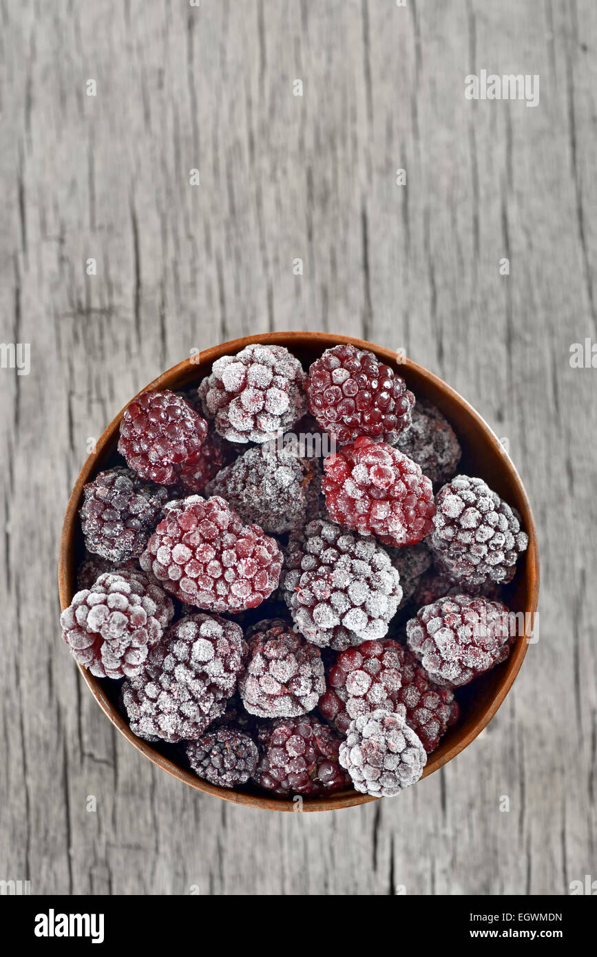 frozen blackberries on old wood table Stock Photo