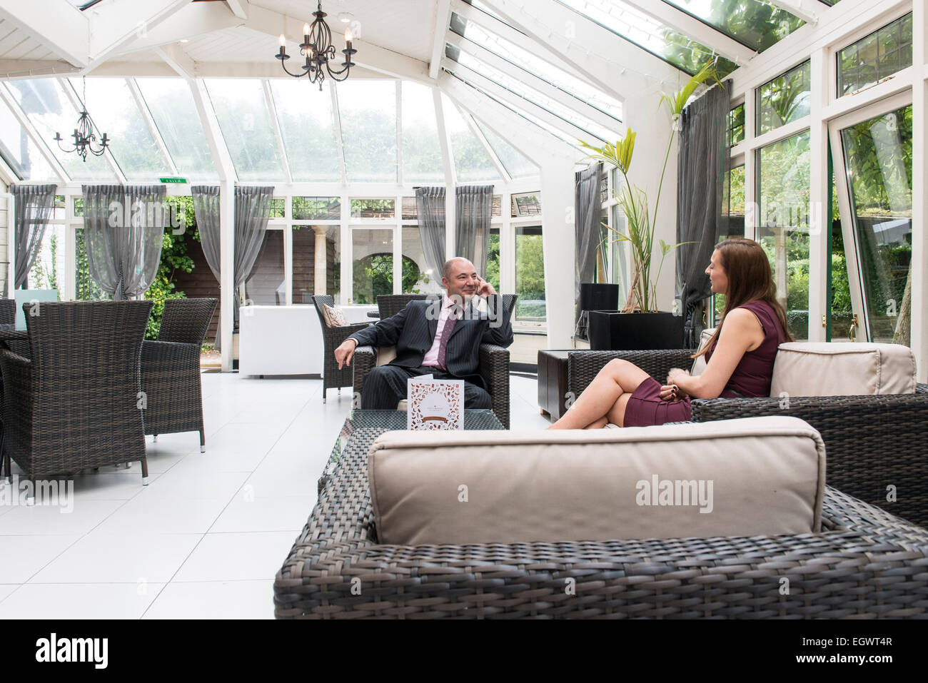 a relaxed professional businessman office manager sits in an armchair at a country house hotel