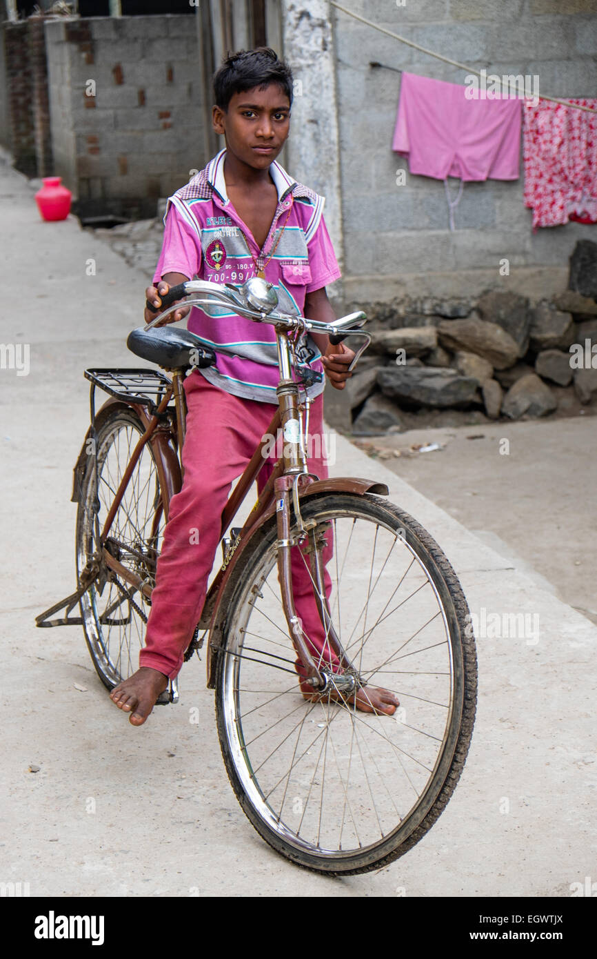 Boy on bike in the back streets of Periyar, India Stock Photo