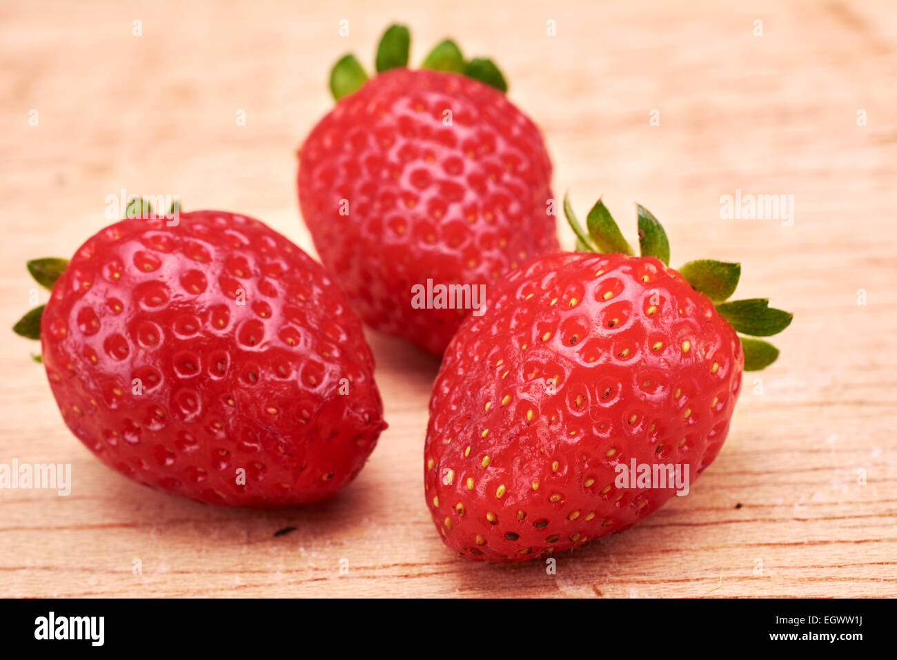 Strawberries in wood background Stock Photo - Alamy