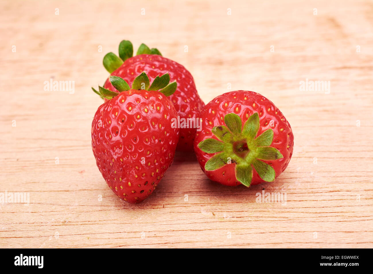 Strawberries in wood background Stock Photo - Alamy