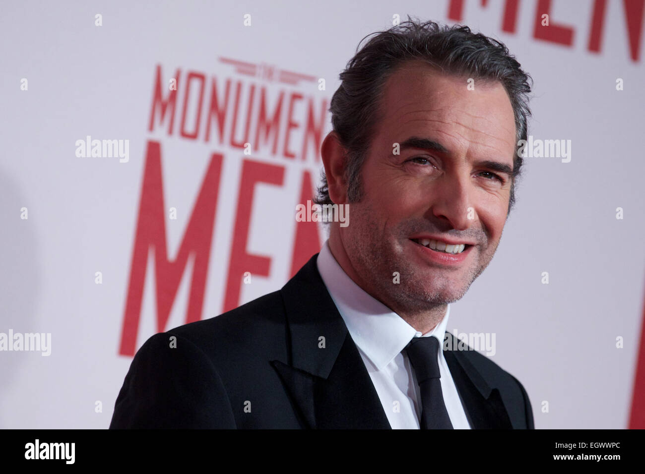 UNITED KINGDOM, London : French actor Jean Dujardin poses for a photo call in front of 'Cupid complaining to Venus' by Lucas Cranach which was a painting that belonged in Hitlers private collection, in conjunction with the film 'The Monument men' in central London on February 11, 2014 Stock Photo