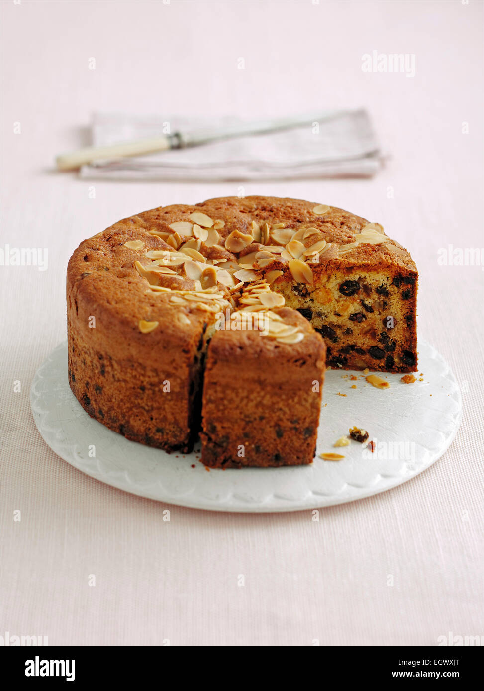 Fruit cake topped with almond flakes, sliced Stock Photo
