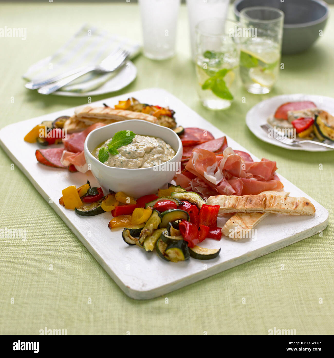 Moroccan platter, roasted vegetables, Parma ham, chorizo, salami, mint dip Stock Photo