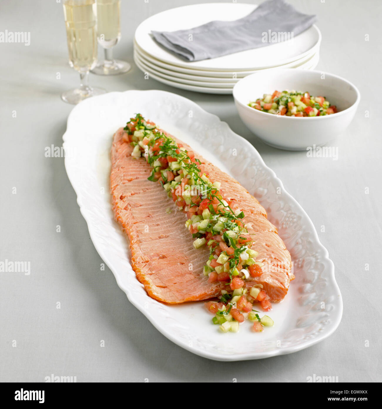 Hot baked trout with tomato and basil salsa Stock Photo