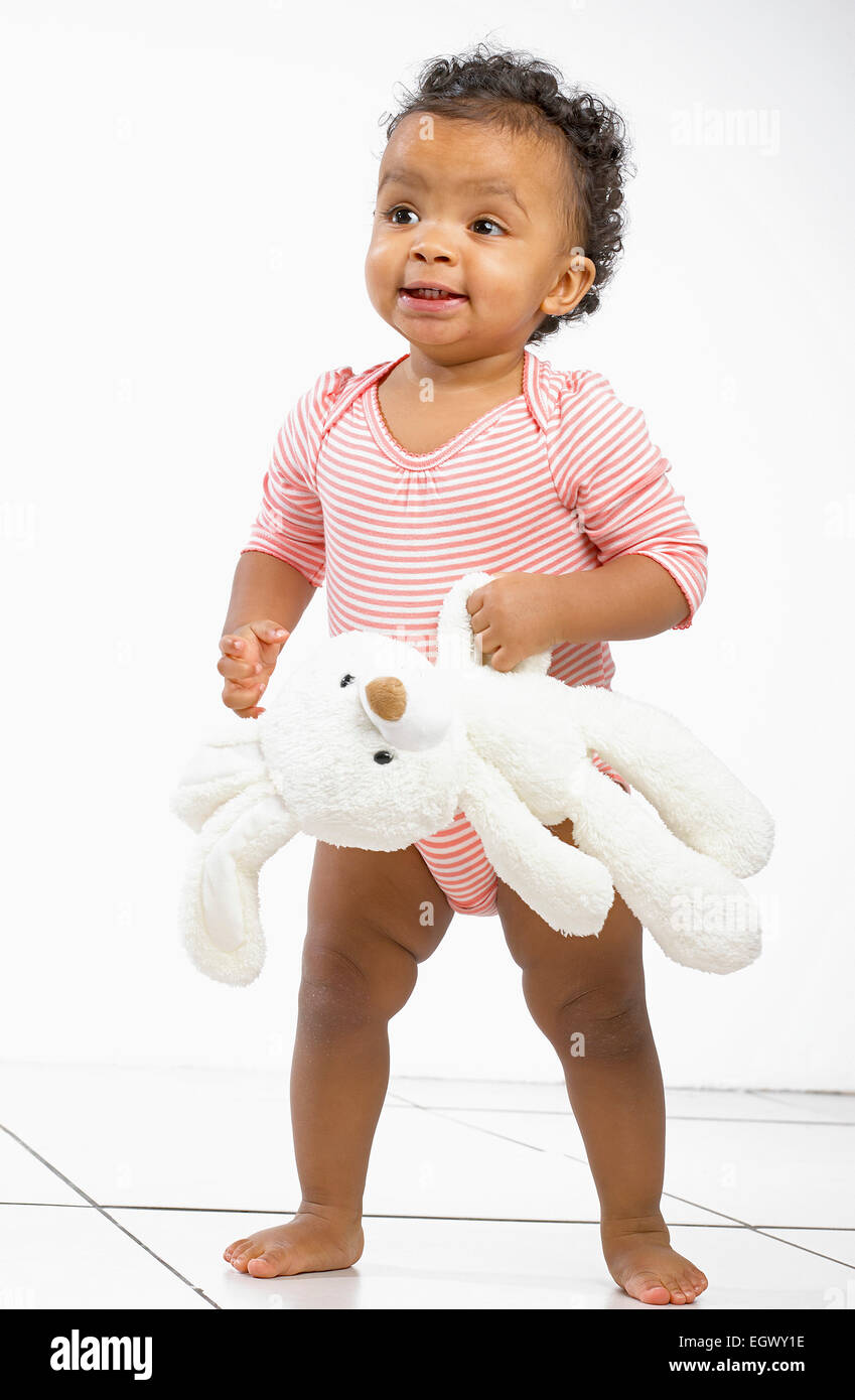 Baby holding cheap toy