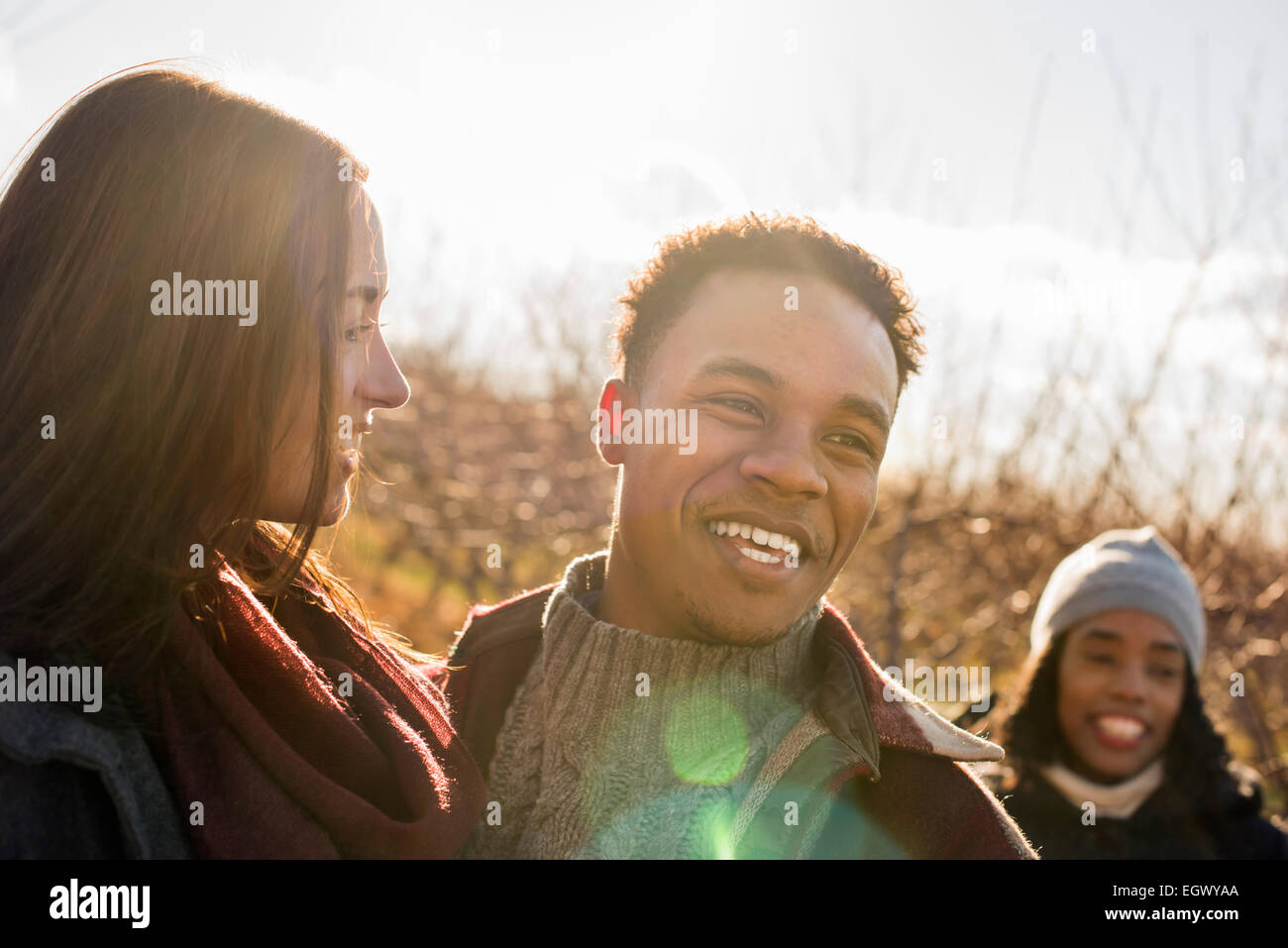 A group of three friends outdoors on a winter walk. Stock Photo