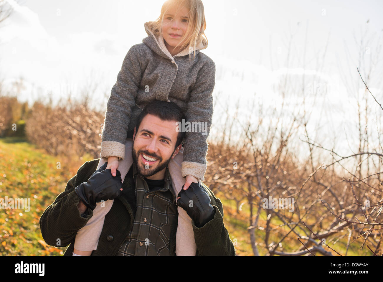 A man giving a child a ride on his shoulders. Stock Photo