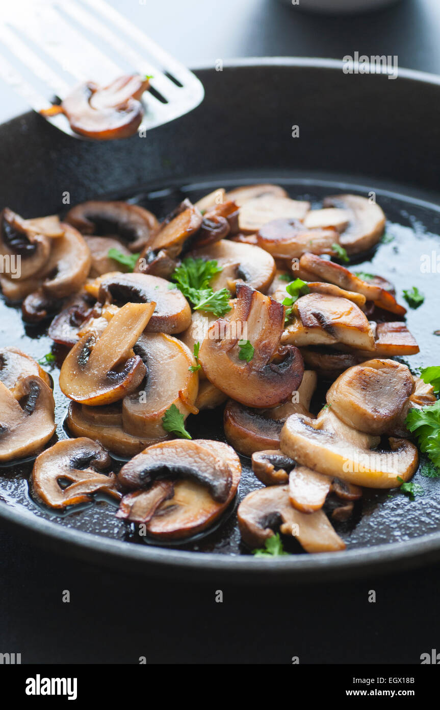 Butter fried sliced mushrooms with parsley in a pan Stock Photo Alamy