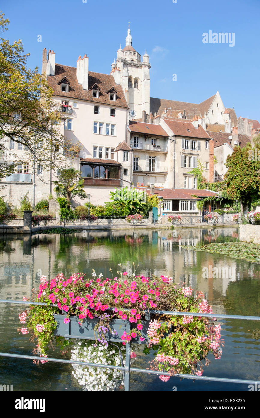 View across Canal des Tanneurs lined with flowers to 16th century Cathedral Notre-Dame in Dole, Jura, Franche-Comte, France Stock Photo