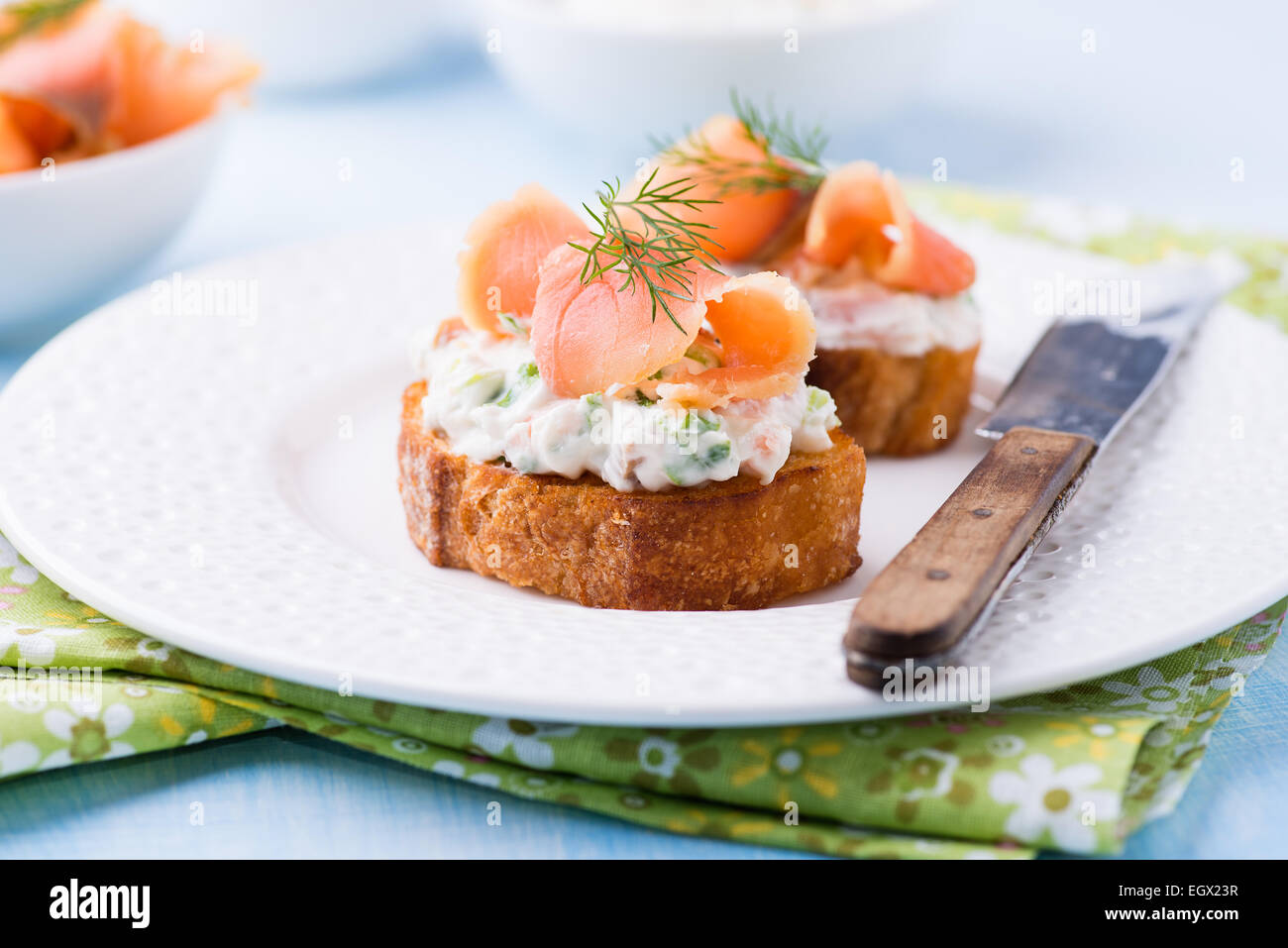 Canape with smoked salmon and cream cheese on plate, selective focus, low angle view Stock Photo
