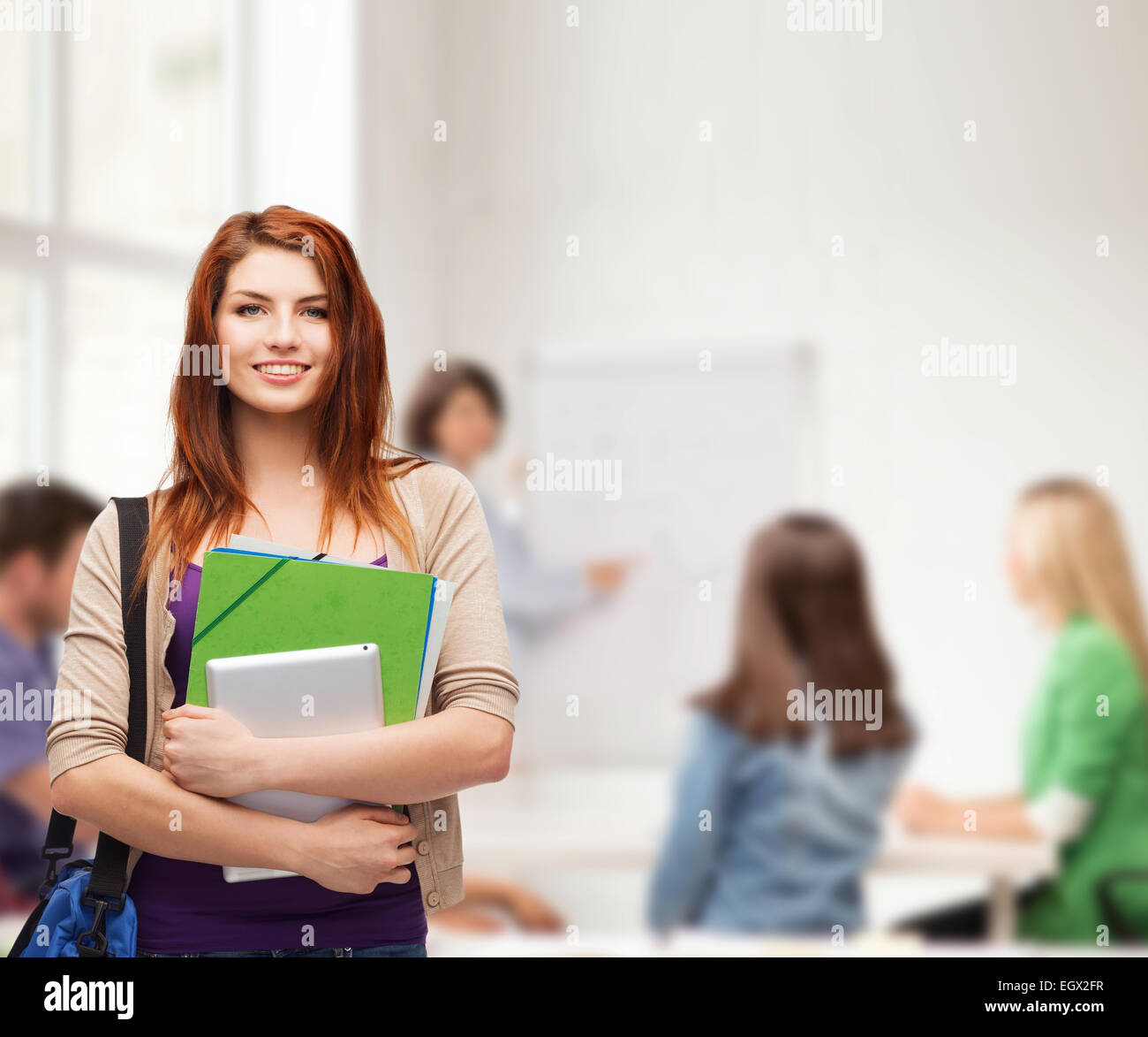 smiling student with bag, folders and tablet pc Stock Photo - Alamy