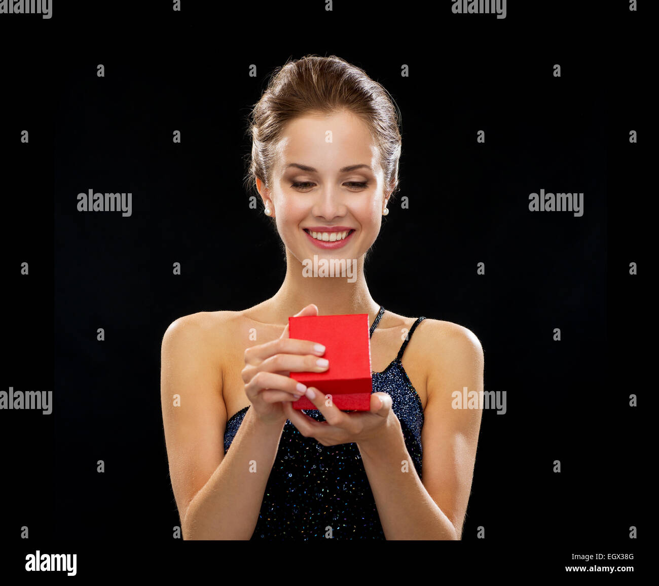 smiling woman holding red gift box Stock Photo - Alamy