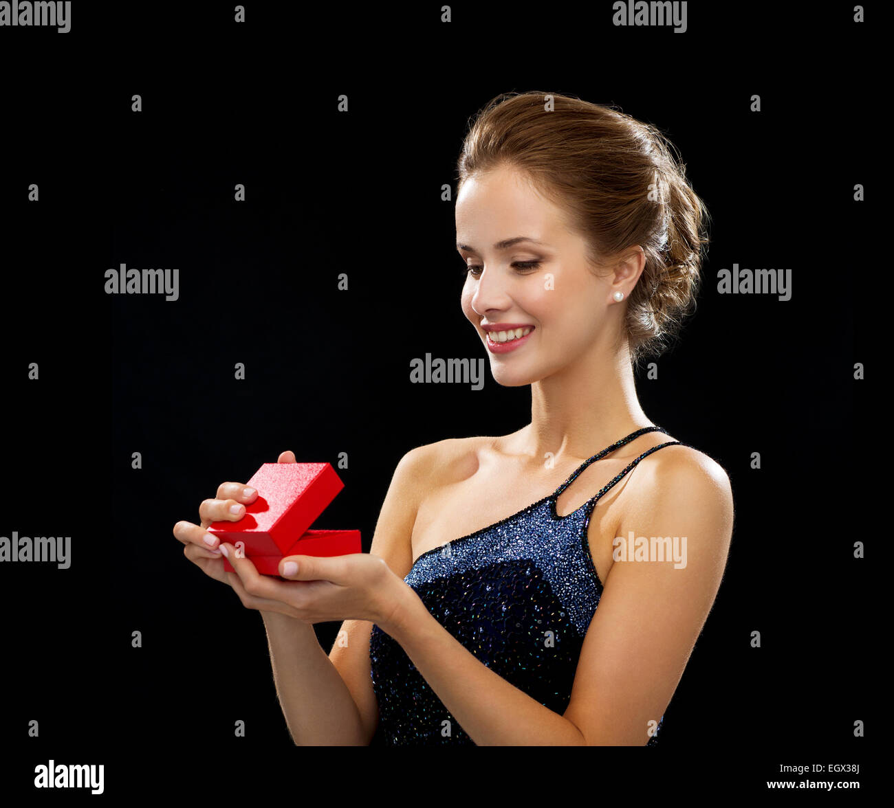 smiling woman holding red gift box Stock Photo - Alamy